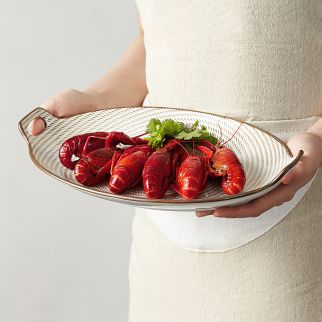 A fish-shaped plate with double handles, 13 inches.